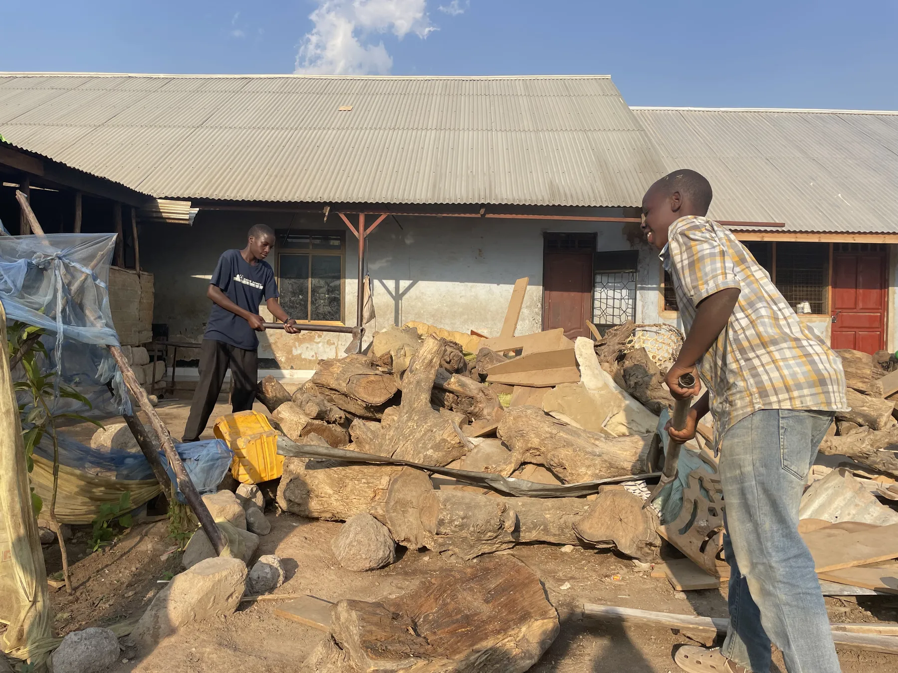Chopping firewood at Watoto Wa Africa