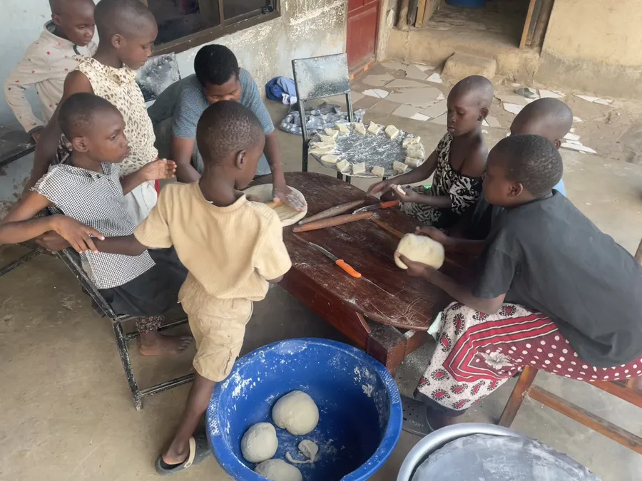 Making mandazi together at Watoto Wa Africa