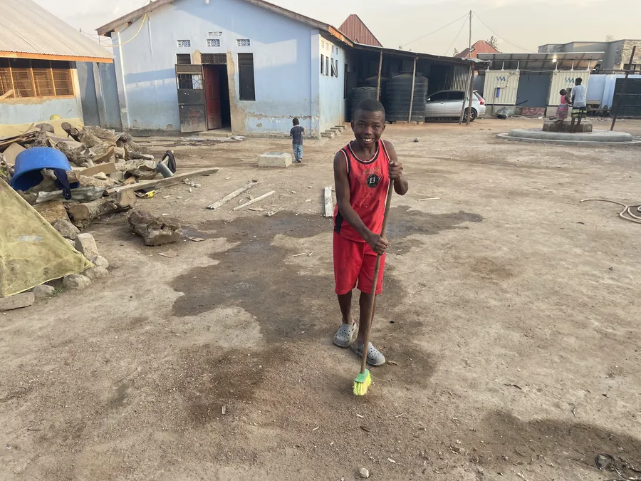 Sweeping the yard at Watoto Wa Africa