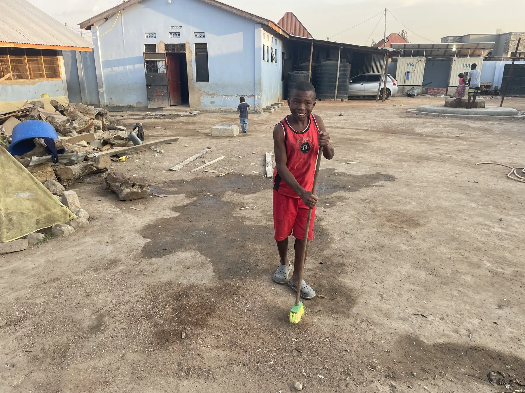 Sweeping the yard at Watoto Wa Africa